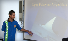 Student presenting using a projector screen